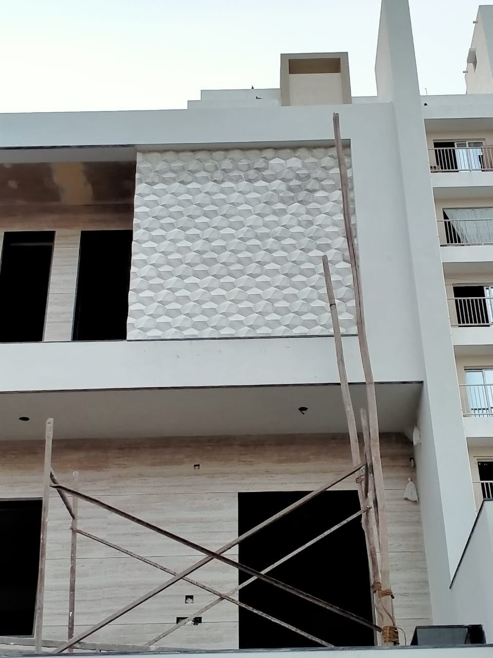 Honeycomb-pattern elevation panels installed on an apartment facade